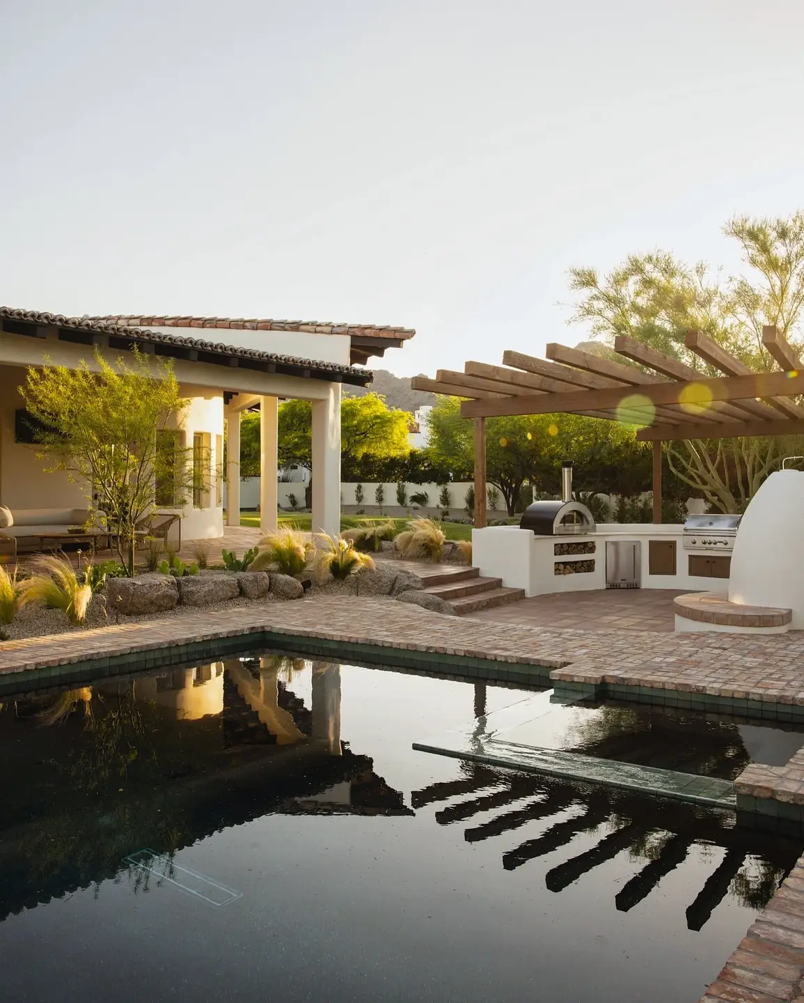 Poolside pergola and planted outdoor living area