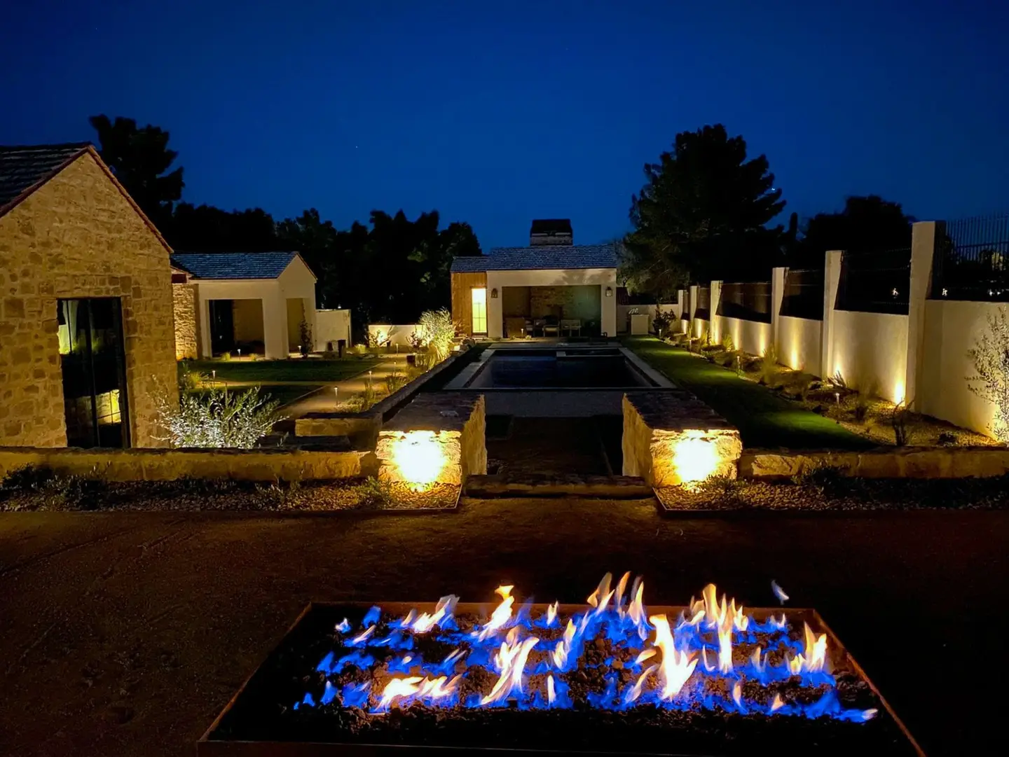 Illuminated desert landscape with a fire feature at night